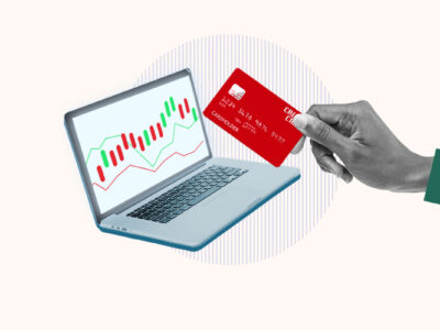 Computer showing stock being bought with a credit card